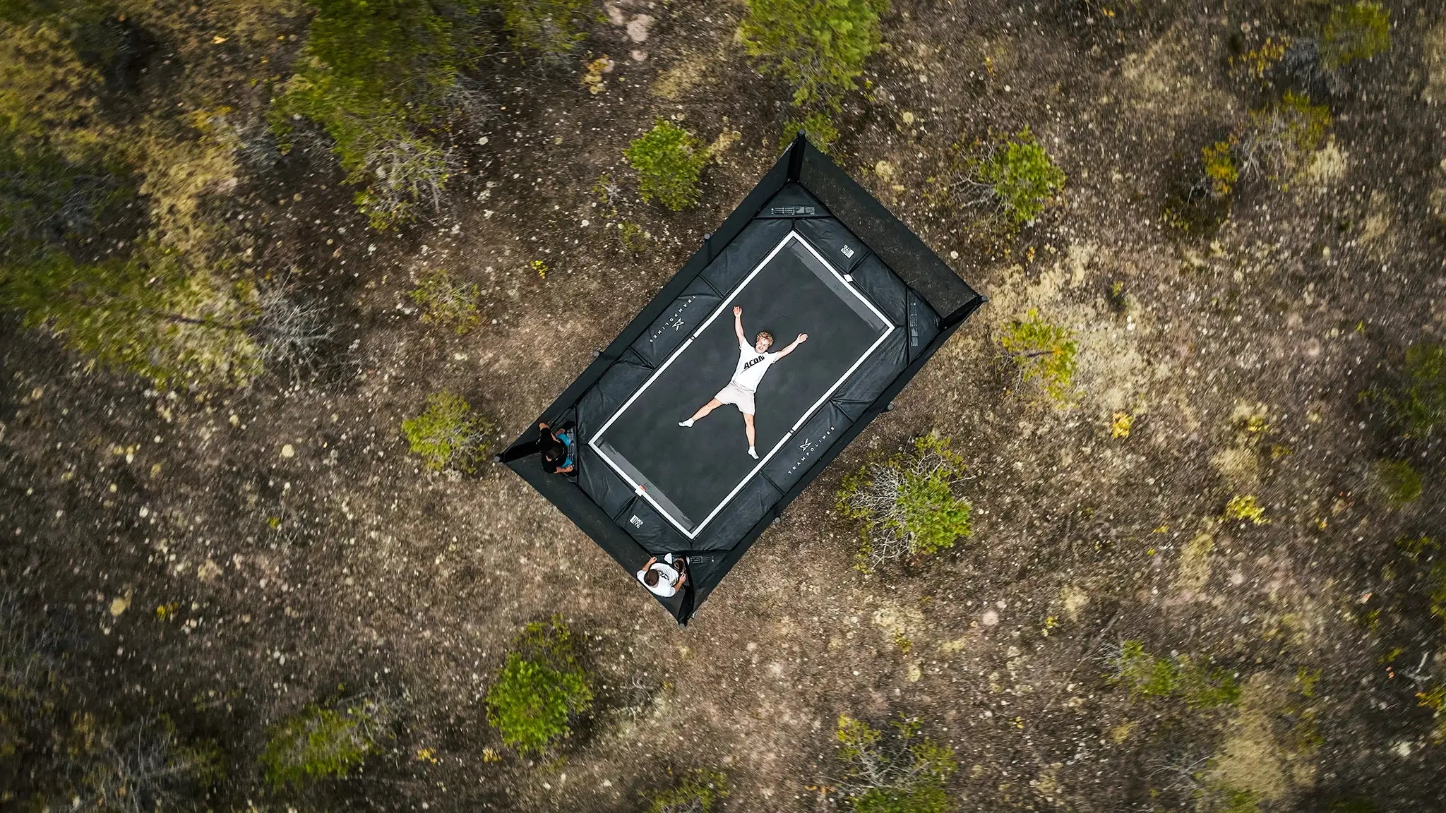 Aearial photo of Acon X, with a man lying on the mat in X position.